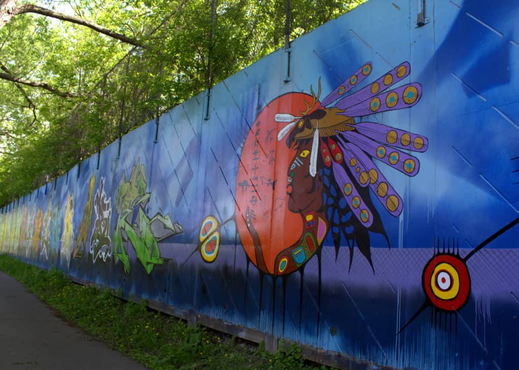 a long mural of indigenous street art